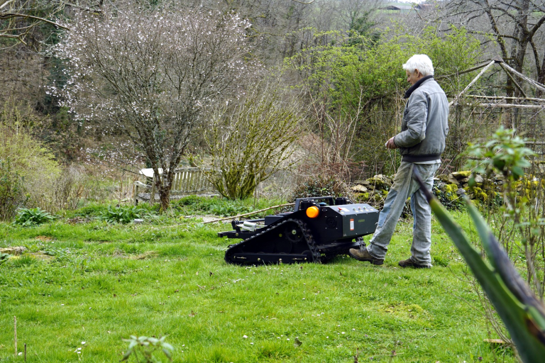 remotely controlled brush cutter with snow plow snow blade snow shovel snow removal machine